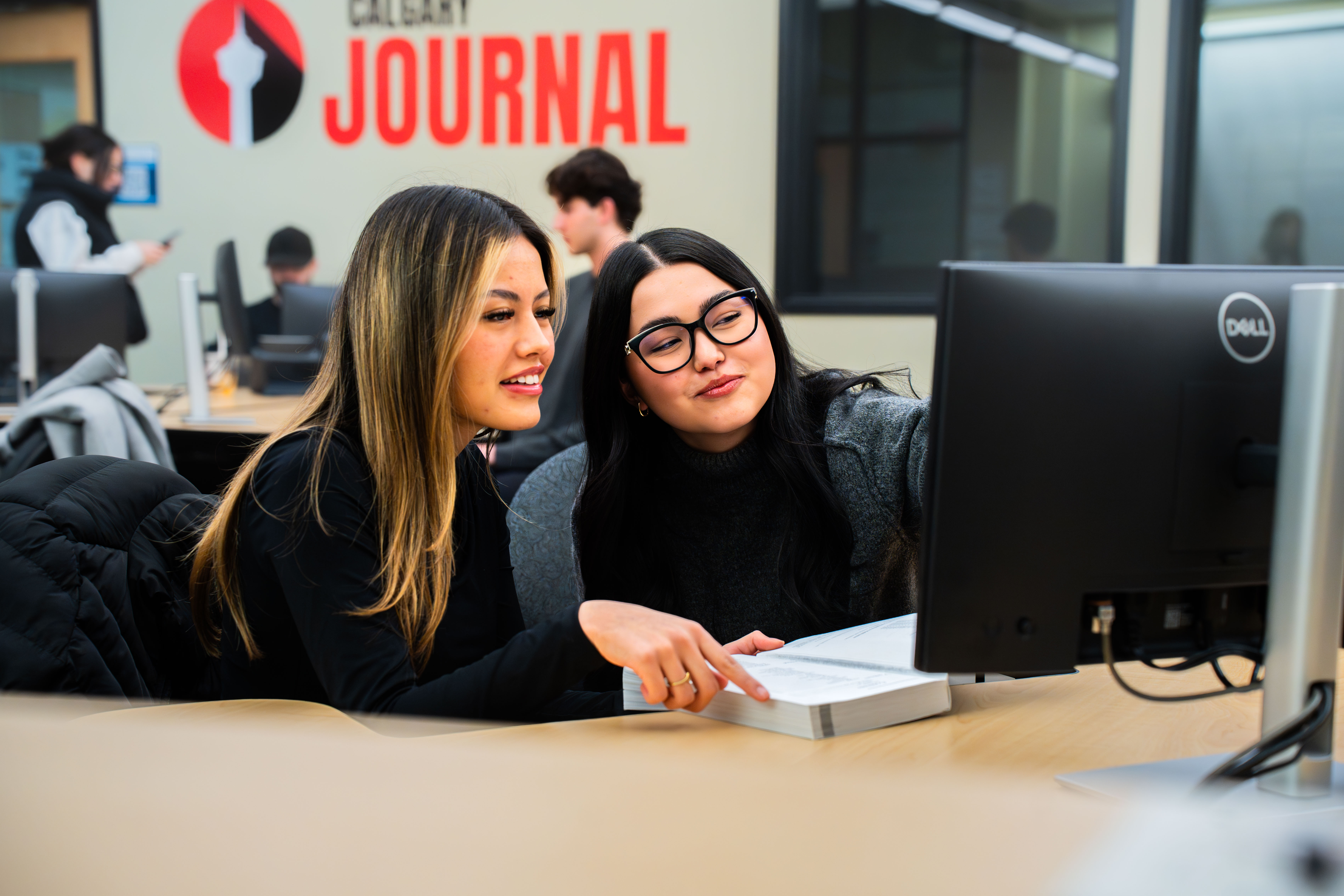 ateam members collaborating in front of computer screen